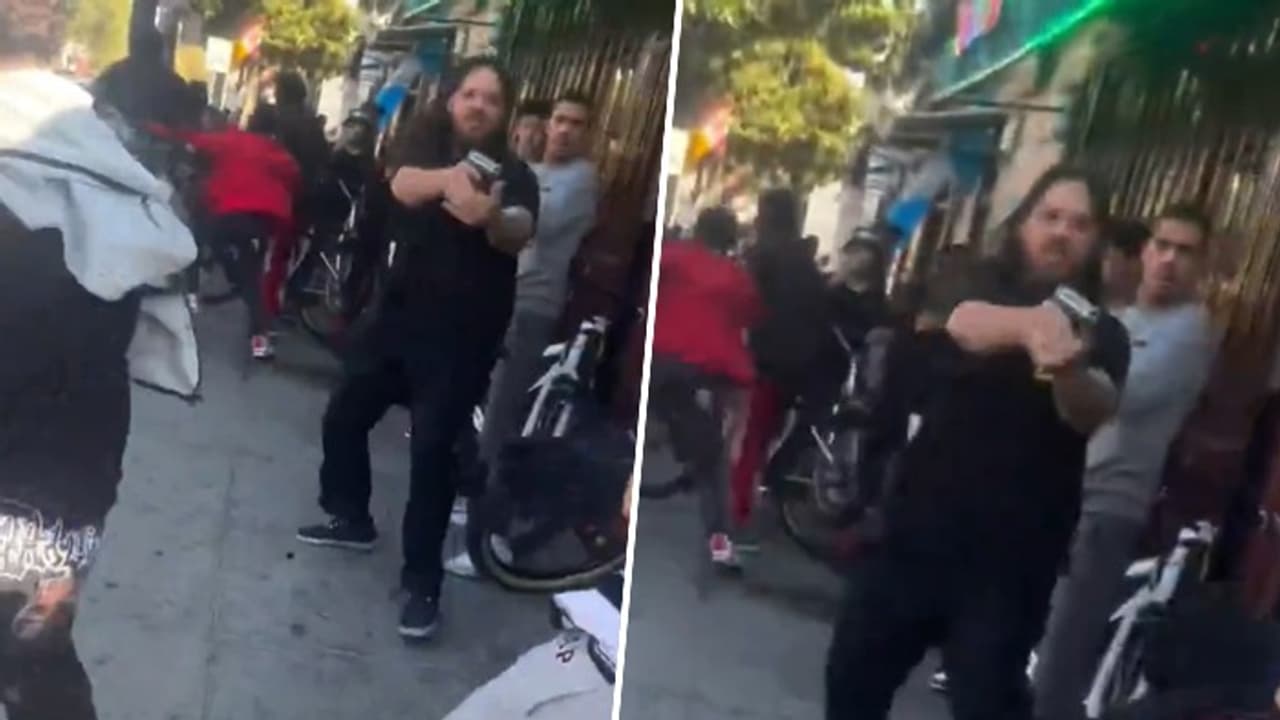 Dramatic video shows California liquor store employee aiming gun as mob charges at him (Watch) Dramatic video shows California liquor store employee aiming gun as mob charges at him (Watch)