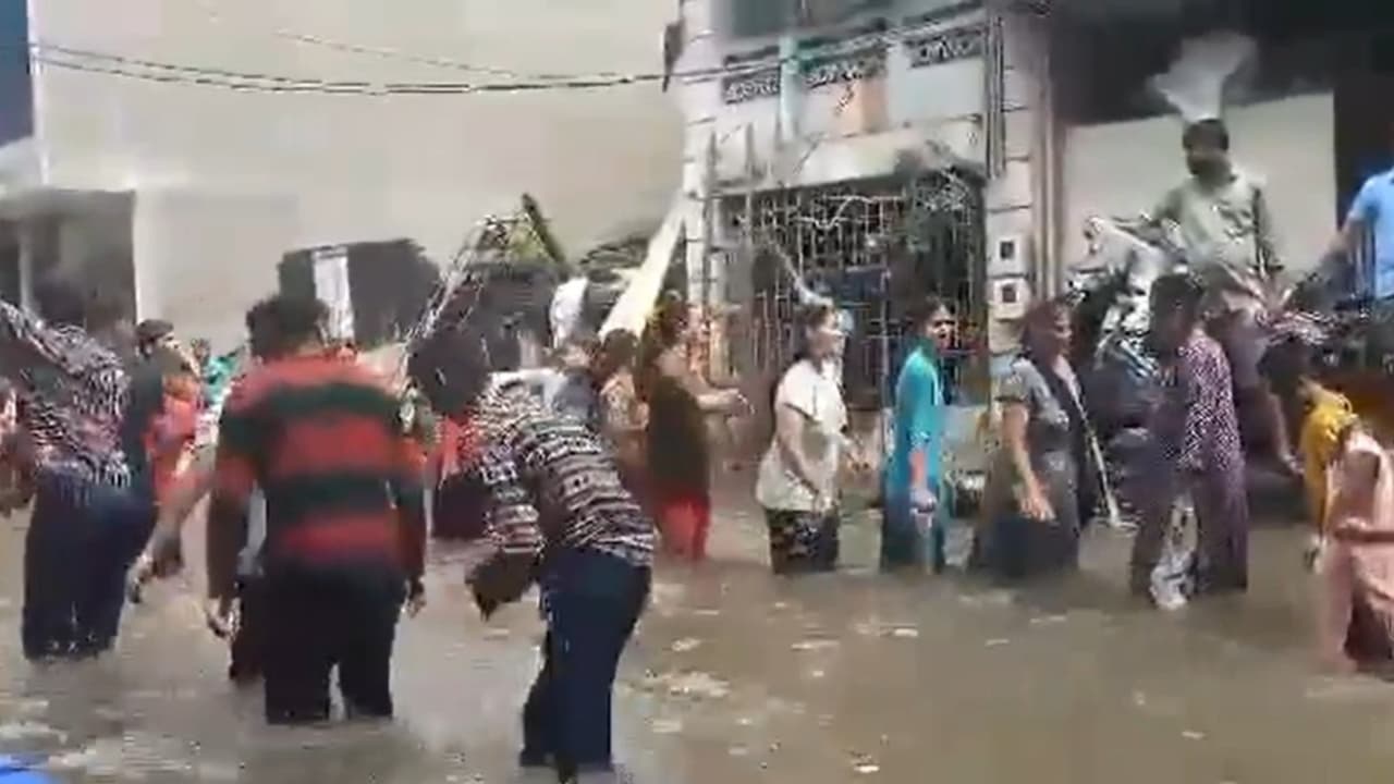 Gujarat's flooded streets turn dance floor as locals perform Garba in knee deep water (Watch) Gujarat's flooded streets turn dance floor as locals perform Garba in knee deep water (Watch)