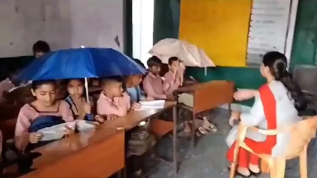 UP: Students forced to study under umbrellas due to leaking roof in Baghpat school, concerns raised (WATCH)