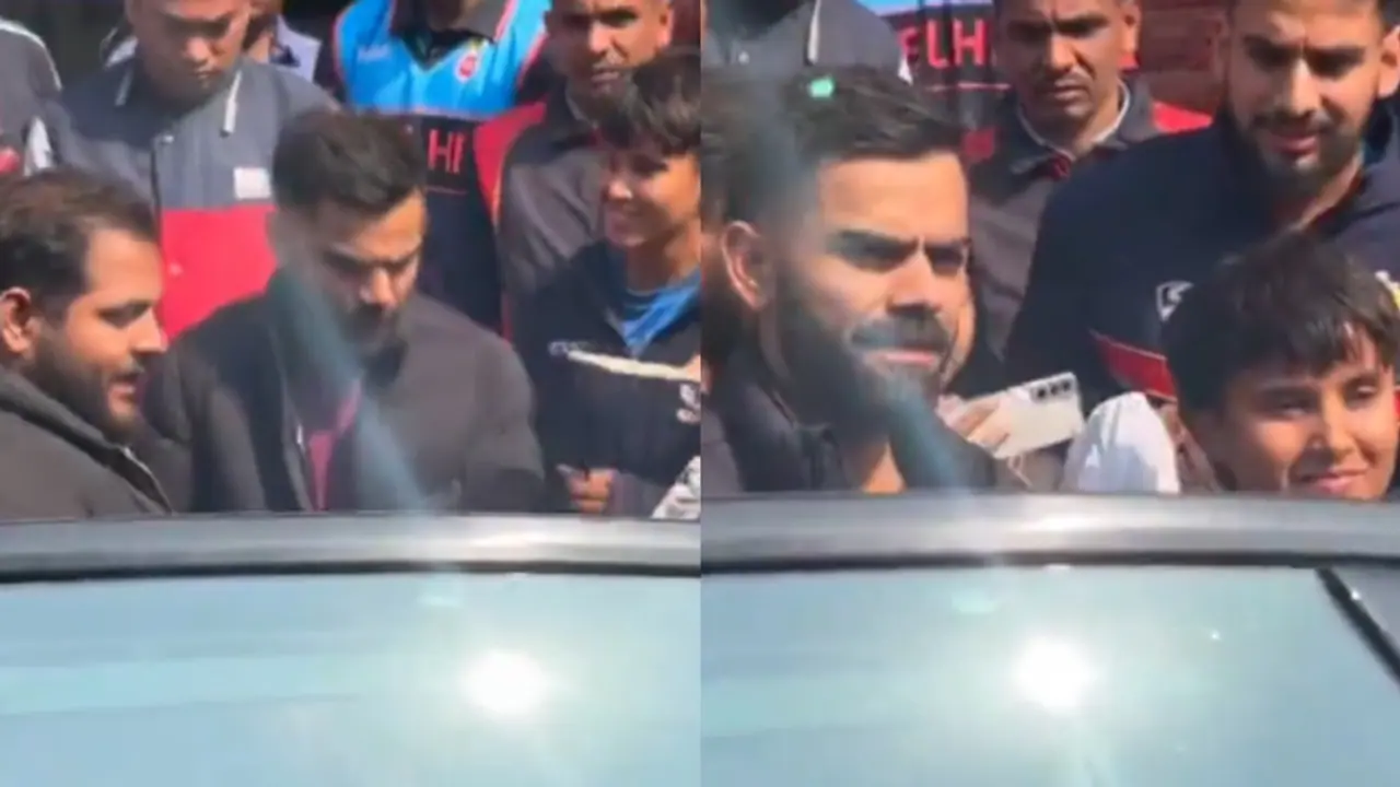 Virat Kohli surrounded by fans for pictures after practice session ahead of his Ranji Trophy return (WATCH) Virat Kohli surrounded by fans for pictures after practice session ahead of his Ranji Trophy return (WATCH)