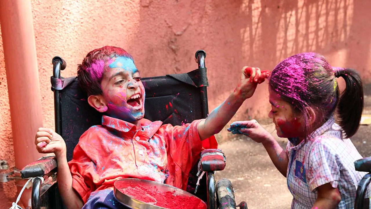 A specially abled boy applies colour to a girl as they celebrate ahead of the Holi festival A specially abled boy applies colour to a girl as they celebrate ahead of the Holi festival