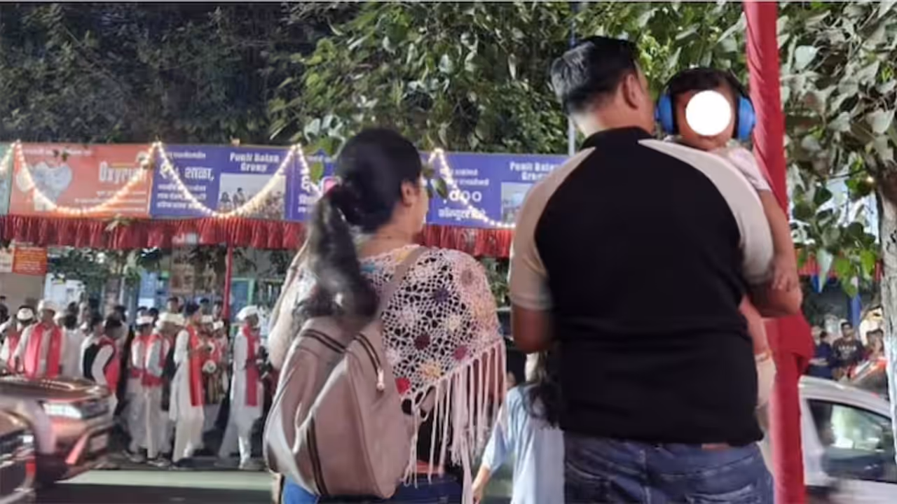 Pune Parents Put Headphones on Baby at Dhol Tasha Procession Pune Parents Put Headphones on Baby at Dhol Tasha Procession