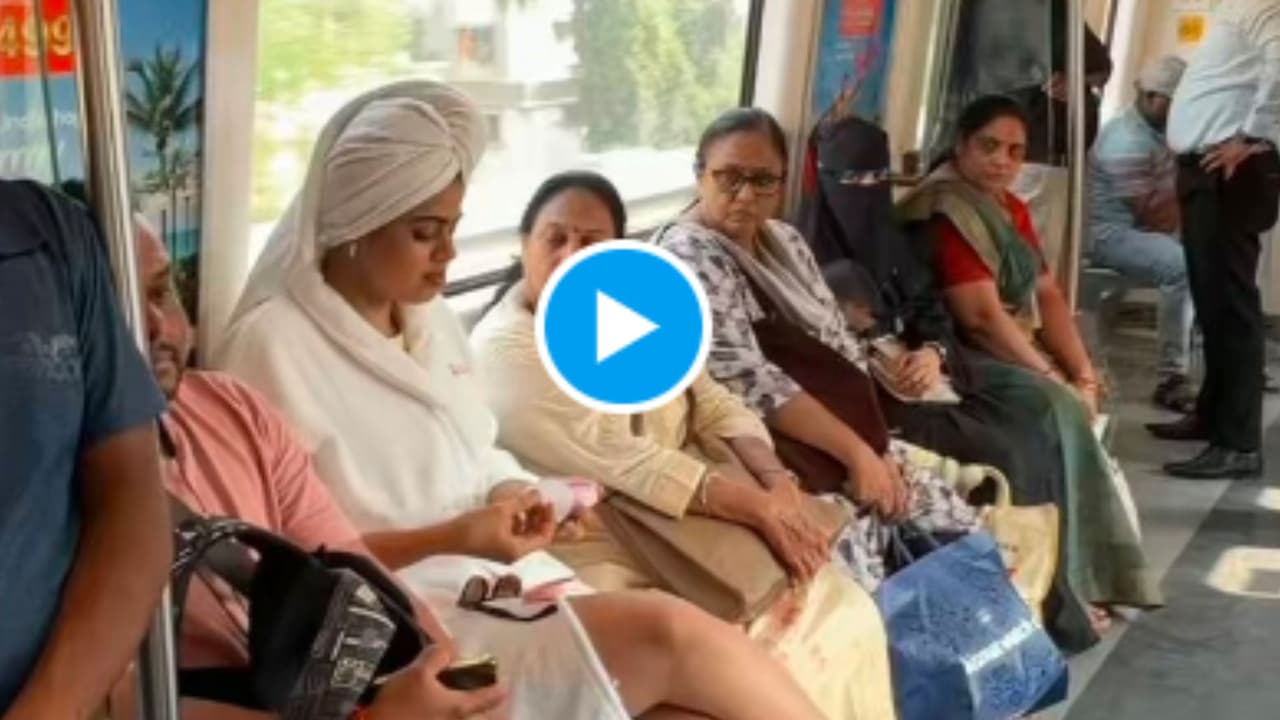 Woman Doing Makeup in Metro Woman Doing Makeup in Metro
