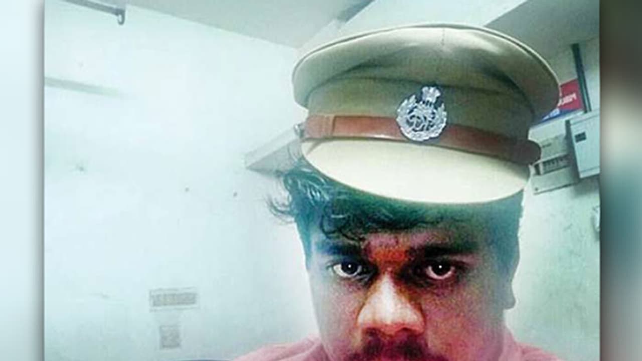 'Police cap selfie' of DYFI leader, arrested for beating up BJP workers, goes viral 'Police cap selfie' of DYFI leader, arrested for beating up BJP workers, goes viral