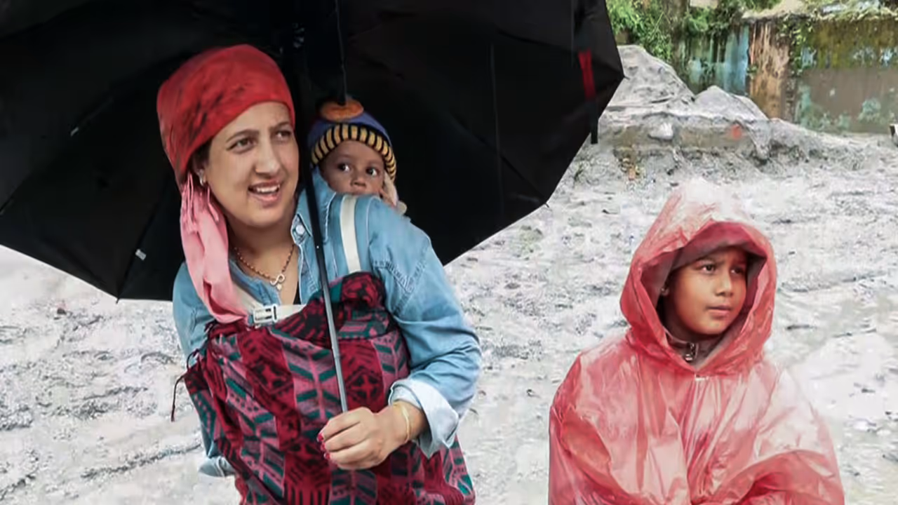 A mother carries one child on her back and another with her after flash floods devastating Trishuli area (Photo/ANI) A mother carries one child on her back and another with her after flash floods devastating Trishuli area (Photo/ANI)