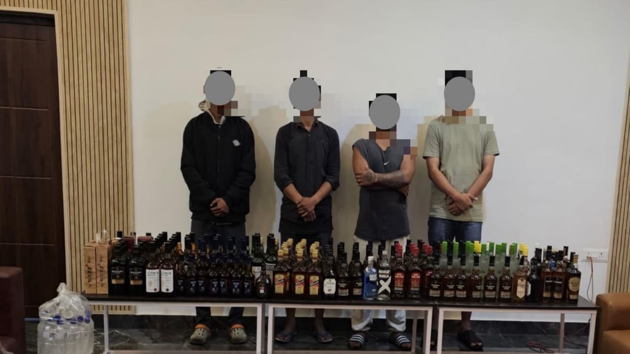 Manipur police with alleged illegal liquor sellers (Photo/Manipur Police Release) Manipur police with alleged illegal liquor sellers (Photo/Manipur Police Release)