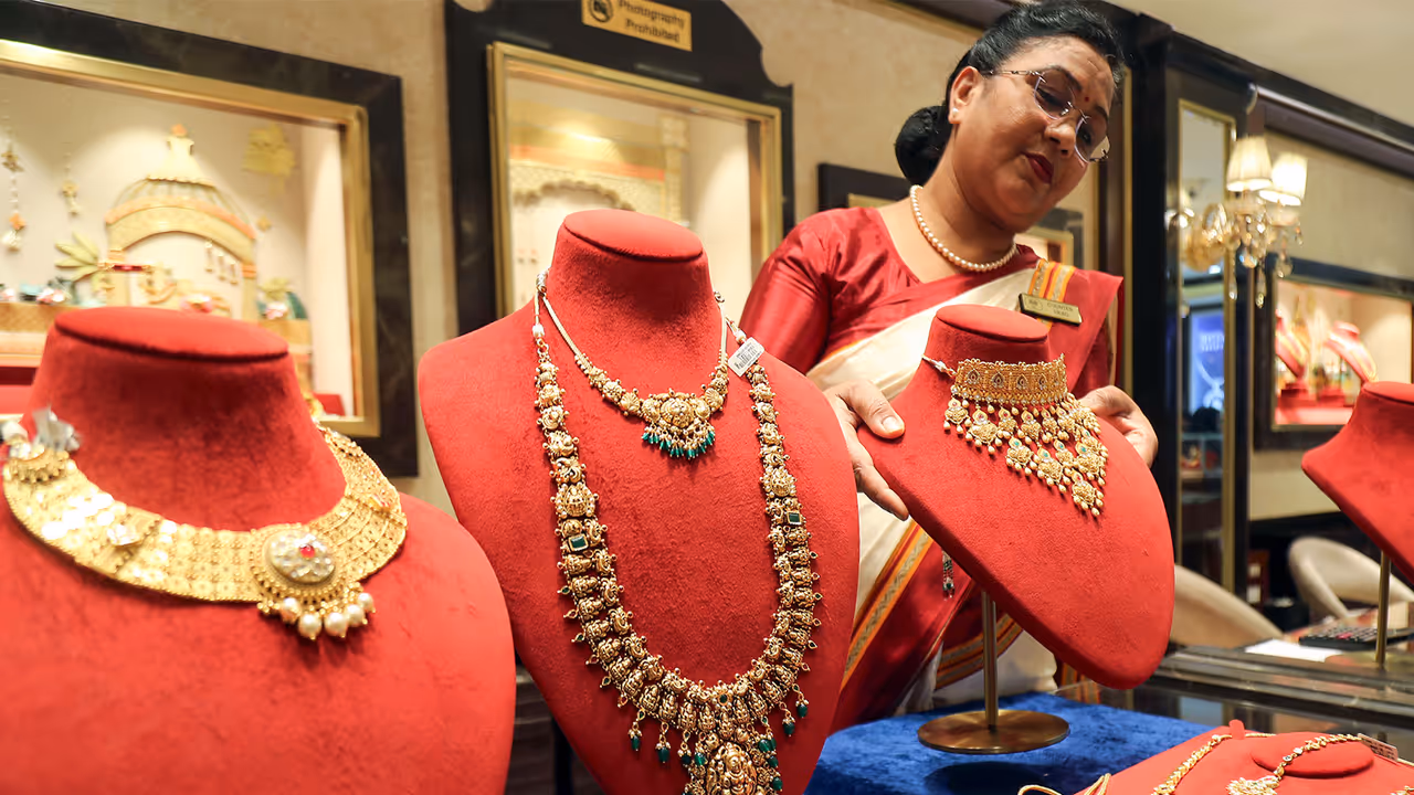 A saleswoman with a gold necklace at a jewellery shop (Photo/ANI) A saleswoman with a gold necklace at a jewellery shop (Photo/ANI)