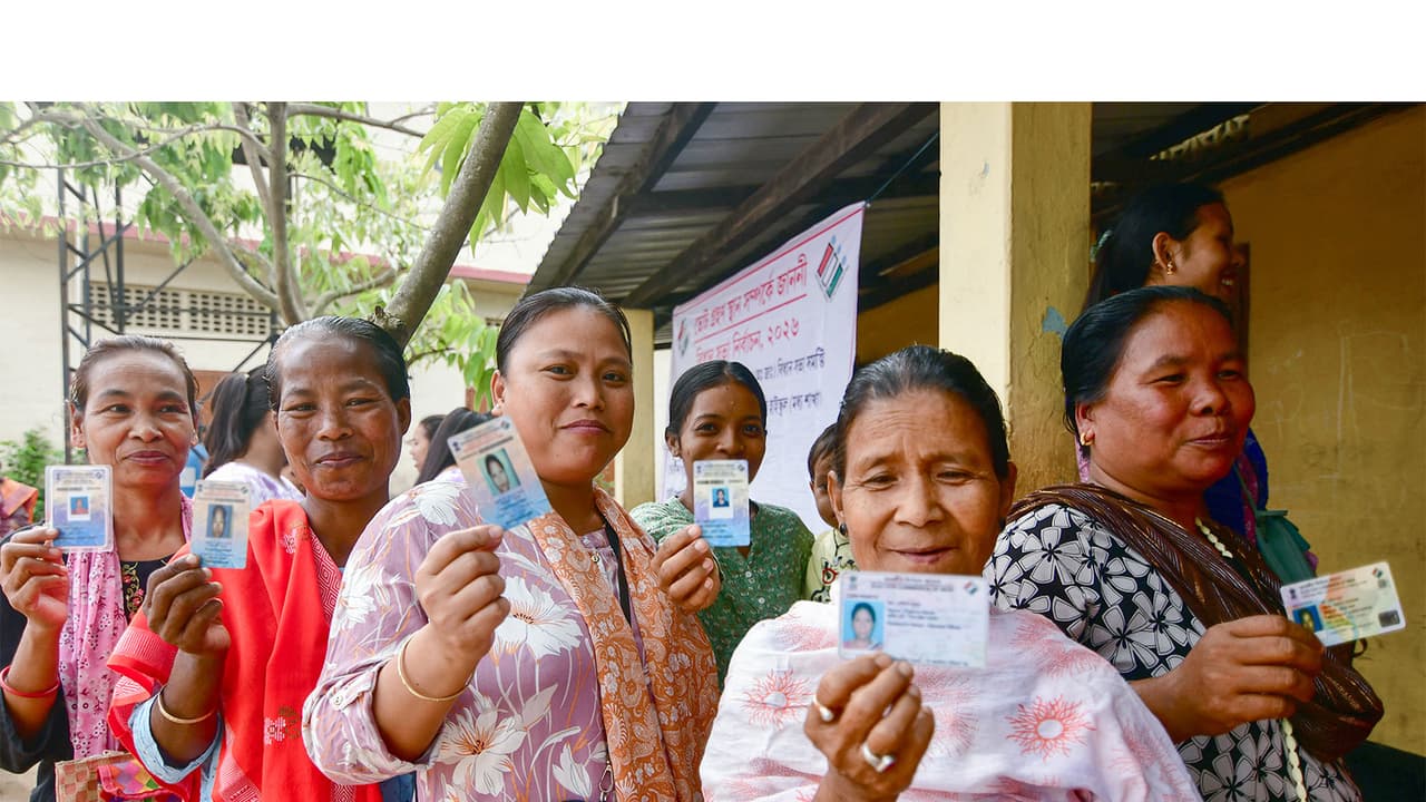 Voters show their voter IDs as they cast their votes at the polling station (Photo/ANI) Voters show their voter IDs as they cast their votes at the polling station (Photo/ANI)