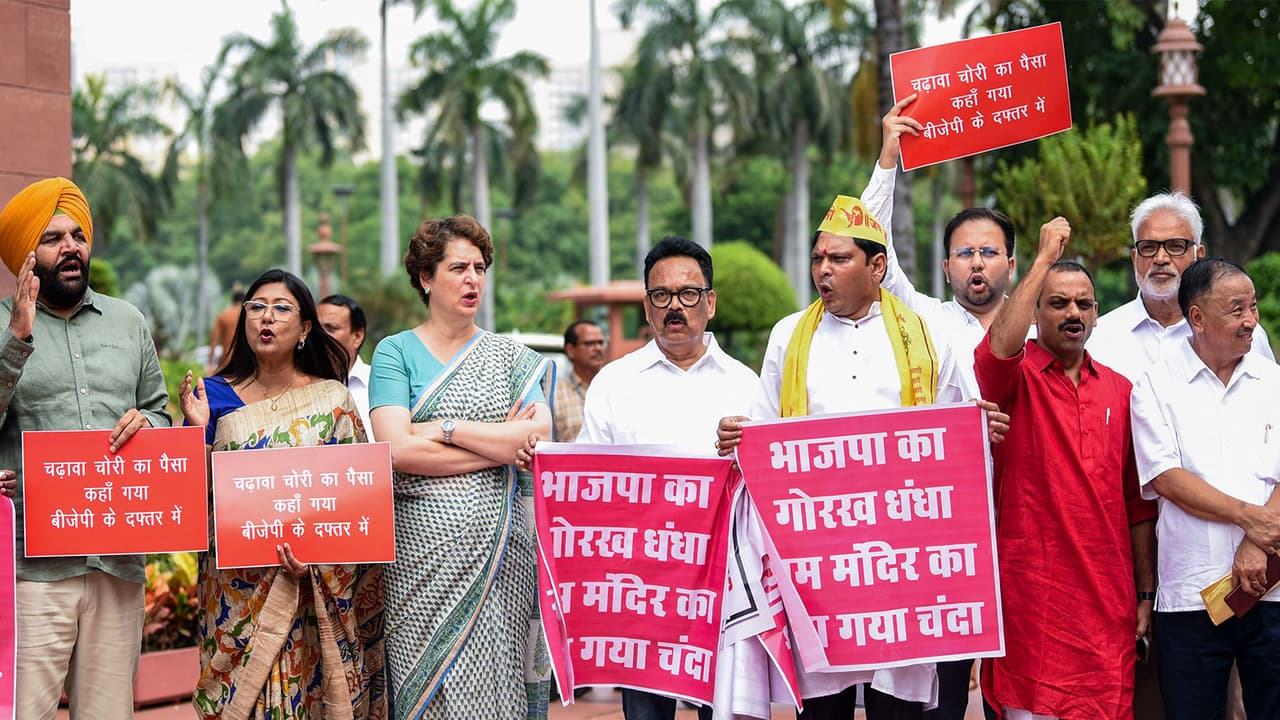 Opposition MPs protest over the issue of alleged Ayodhya Ram Mandir donations embezzlement during the Parliament Monsoon Session (Photo/ANI) Opposition MPs protest over the issue of alleged Ayodhya Ram Mandir donations embezzlement during the Parliament Monsoon Session (Photo/ANI)