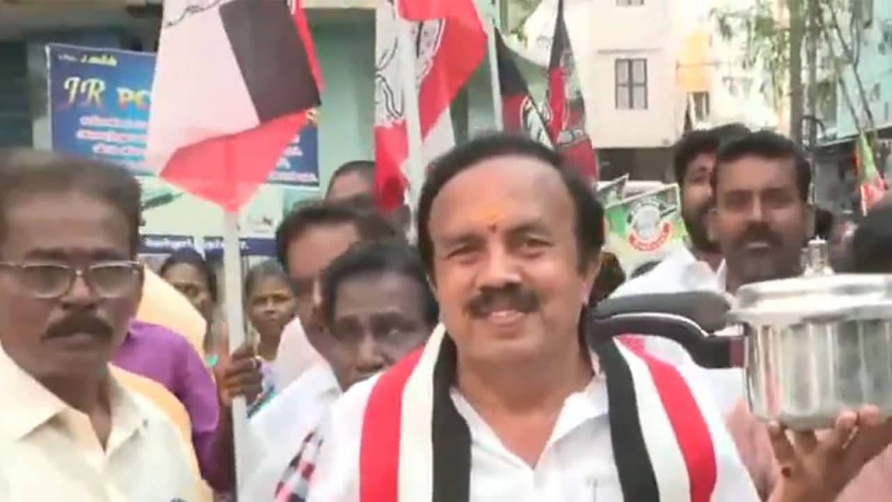 AMMK candidate Rajasekaran, contesting from Tiruchirappalli West, carries out door to door campaign in the Tennur area along with NDA allies BJP, AIADMK and PMK cadres, seeking support for the ‘Pressure Cooker’ symbol ahead of Tamil Nadu elections (Photo/ANI) AMMK candidate Rajasekaran, contesting from Tiruchirappalli West, carries out door to door campaign in the Tennur area along with NDA allies BJP, AIADMK and PMK cadres, seeking support for the ‘Pressure Cooker’ symbol ahead of Tamil Nadu elections (Photo/ANI)