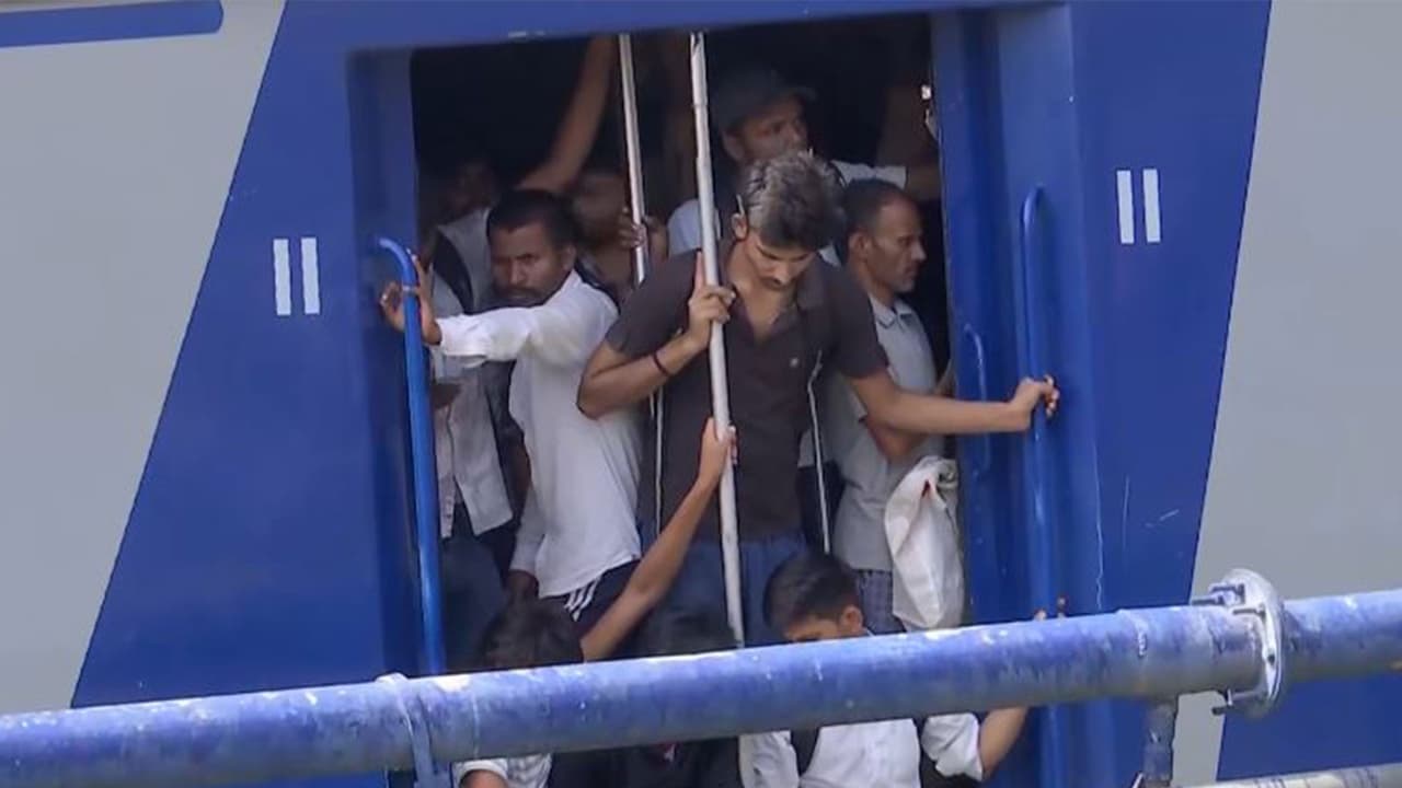 Students hang at train doors amid heavy rush (Photo/ANI) Students hang at train doors amid heavy rush (Photo/ANI)