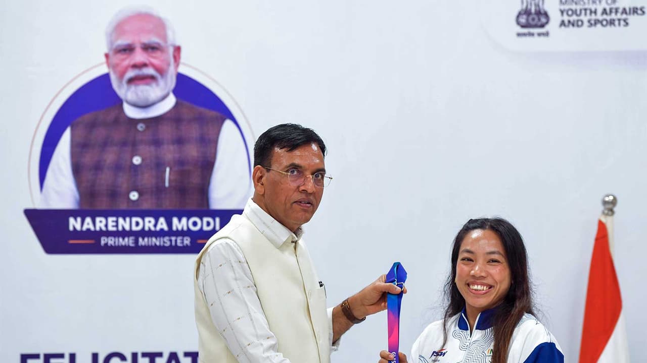 Mansukh Mandaviya felicitating women's 48kg gold medallist Mirabai Chanu during a ceremony honouring the weightlifting contingent for its performance at CWG 2026 (Photo: ANI) Mansukh Mandaviya felicitating women's 48kg gold medallist Mirabai Chanu during a ceremony honouring the weightlifting contingent for its performance at CWG 2026 (Photo: ANI)