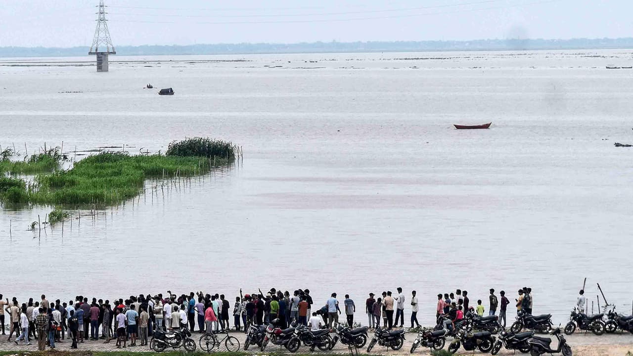 People watch as the water level of the Ganga rises (Photo: ANI) People watch as the water level of the Ganga rises (Photo: ANI)
