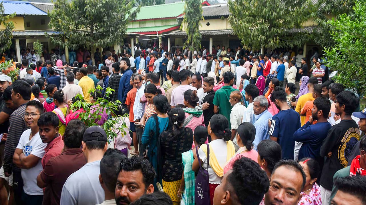 Voters wait in queues to cast their votes at a polling station in Assam. (Photo/ANI) Voters wait in queues to cast their votes at a polling station in Assam. (Photo/ANI)