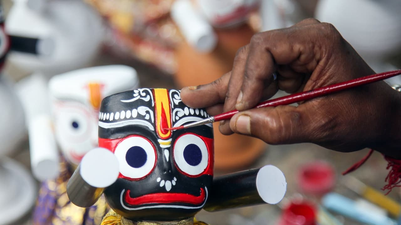 An artisan painting the facial features of a Lord Jagannath idol (Photo/ANI) An artisan painting the facial features of a Lord Jagannath idol (Photo/ANI)
