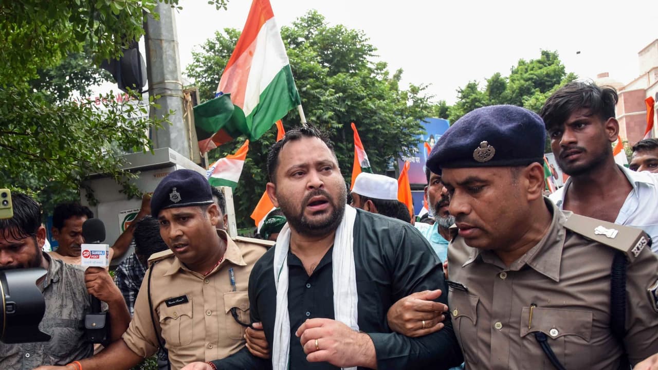 Police detain Bihar Assembly LoP and RJD leader Tejashwi Yadav during a foot march towards Lok Bhawan (Photo/ANI) Police detain Bihar Assembly LoP and RJD leader Tejashwi Yadav during a foot march towards Lok Bhawan (Photo/ANI)