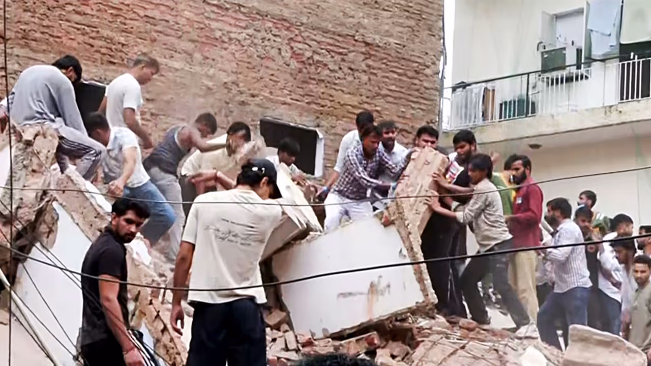 People remove debris during a rescue operation at the site of a building collapse near Satya Niketan in South West Delhi (Photo/ANI) People remove debris during a rescue operation at the site of a building collapse near Satya Niketan in South West Delhi (Photo/ANI)