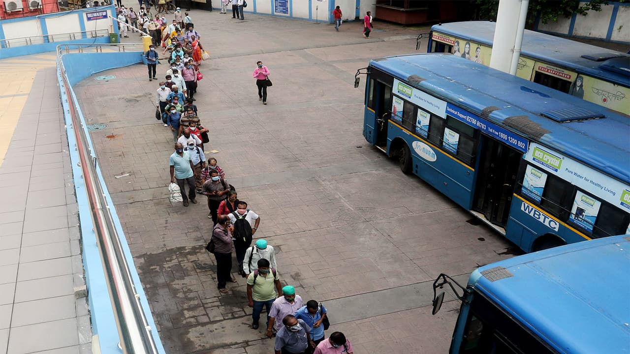 Commuters stand in a queue to board a bus as WBTC (Photo/ANI) Commuters stand in a queue to board a bus as WBTC (Photo/ANI)