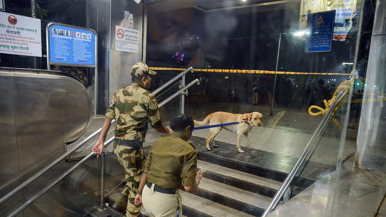 Security personnel with a sniffer dog at the Lal Quila metro station's gate no 1 (Photo/ANI)