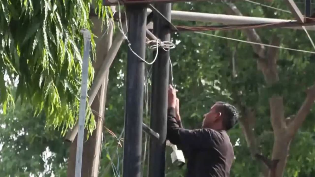 A person installing CCTV camera in an exam centre in New Delhi (Photo/ANI) A person installing CCTV camera in an exam centre in New Delhi (Photo/ANI)