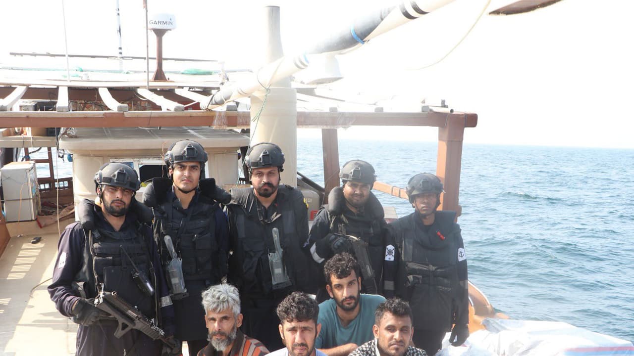 Indian Coast Guard personnel pose with detained foreign crew members and seized cartons of smuggled foreign brand cigarettes aboard the intercepted vessel in the Arabian Sea. (Photo: X/@IndiaCoastGuard) Indian Coast Guard personnel pose with detained foreign crew members and seized cartons of smuggled foreign brand cigarettes aboard the intercepted vessel in the Arabian Sea. (Photo: X/@IndiaCoastGuard)