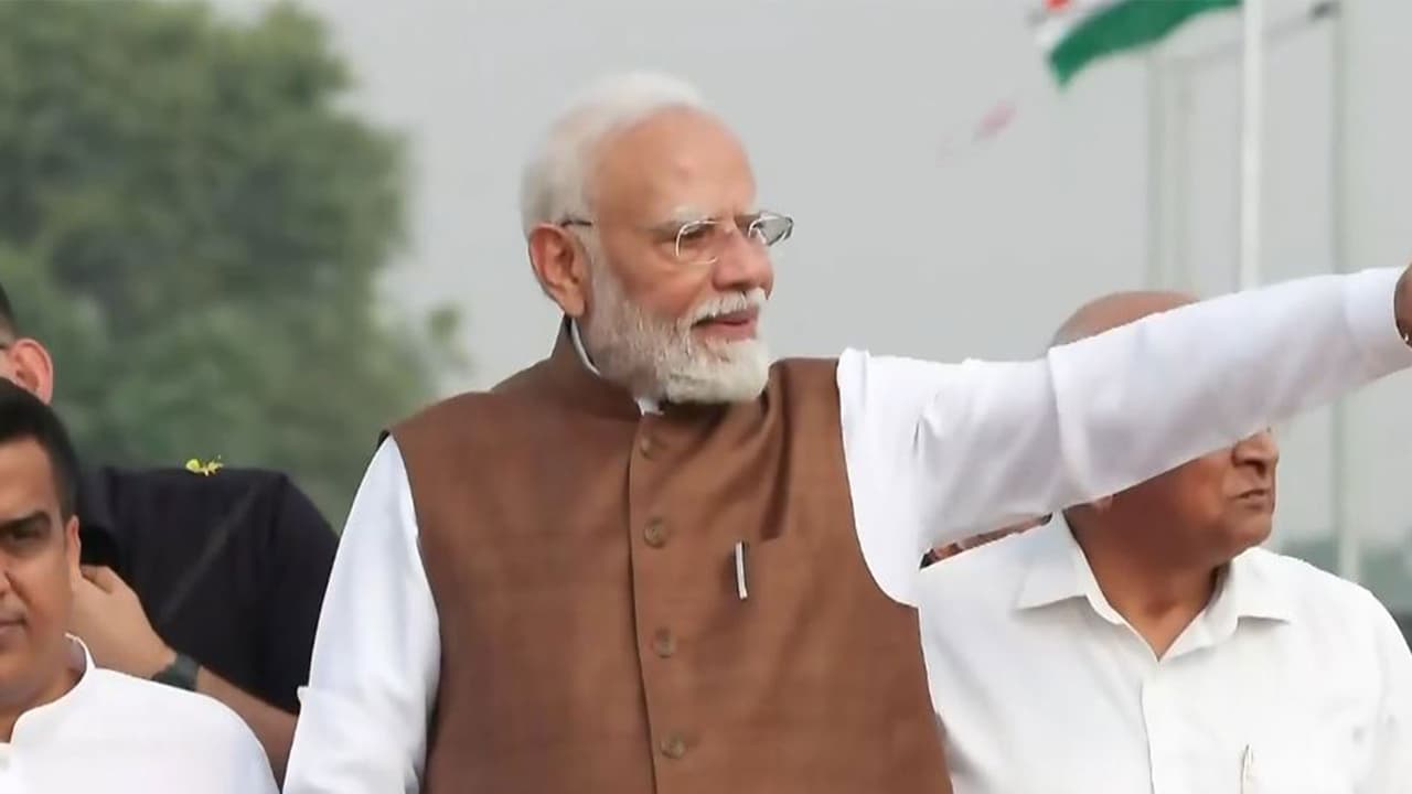 Visual showing Prime Minister Narendra Modi holding a roadshow in Banaskantha, Gujarat (Source: DD) Visual showing Prime Minister Narendra Modi holding a roadshow in Banaskantha, Gujarat (Source: DD)