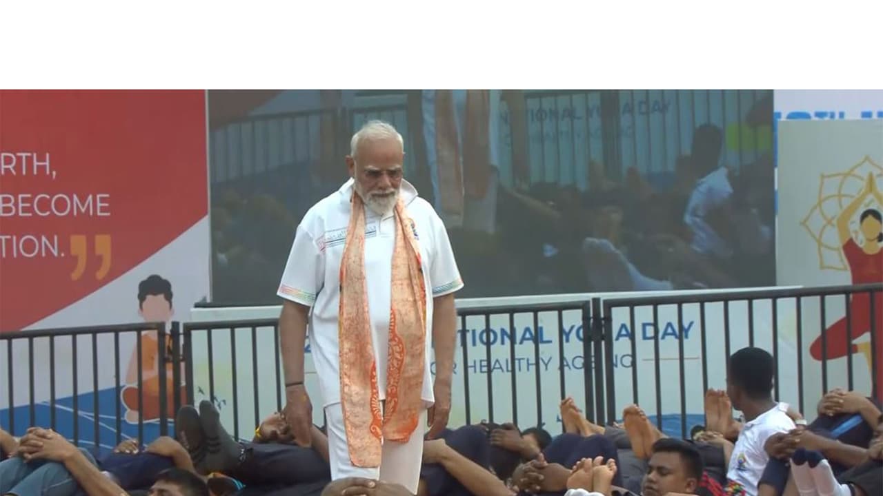 PM Narendra Modi helps participants correct their posture as they perform yoga (Photo/DD) PM Narendra Modi helps participants correct their posture as they perform yoga (Photo/DD)