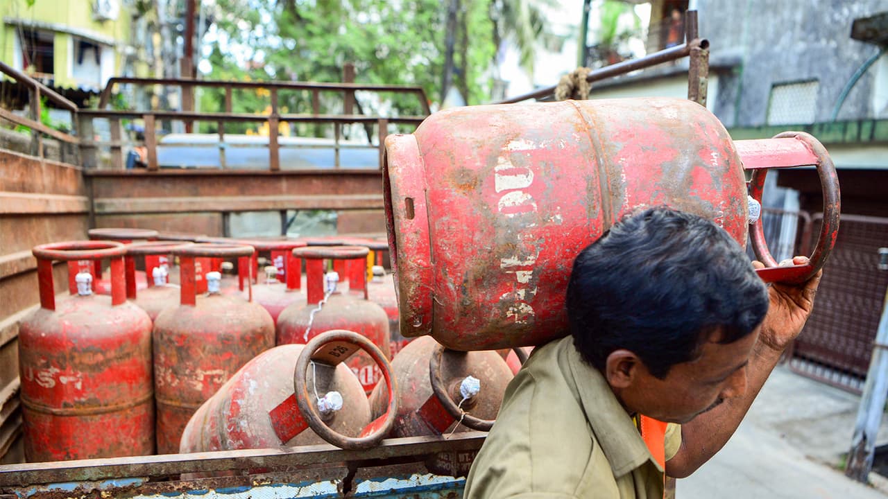 A worker carries an LPG cylinder (File Photo/ANI) A worker carries an LPG cylinder (File Photo/ANI)