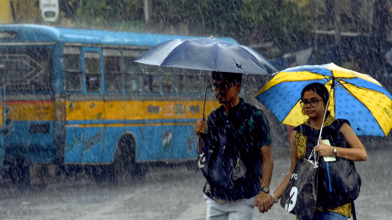 People walk under umbrellas amid heavy monsoon showers (File Photo/ANI) People walk under umbrellas amid heavy monsoon showers (File Photo/ANI)
