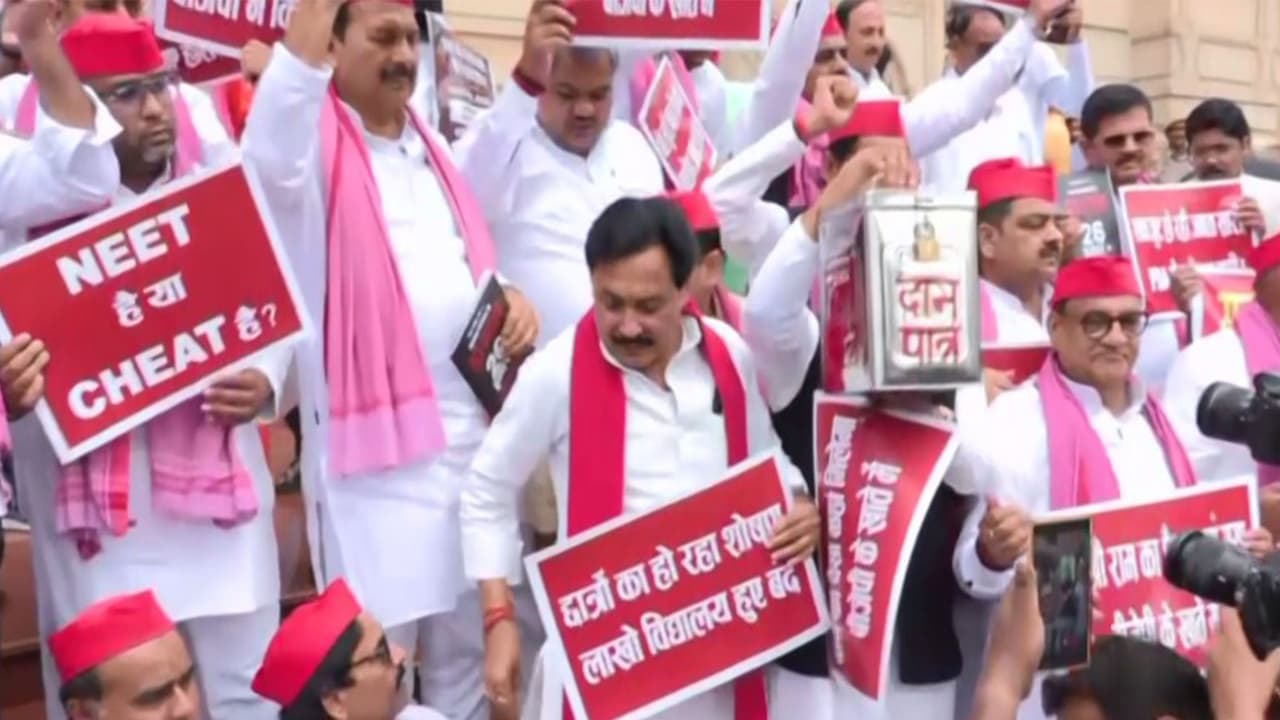Samajwadi Party MLAs protest outside UP assembly (Photo/ANI) Samajwadi Party MLAs protest outside UP assembly (Photo/ANI)
