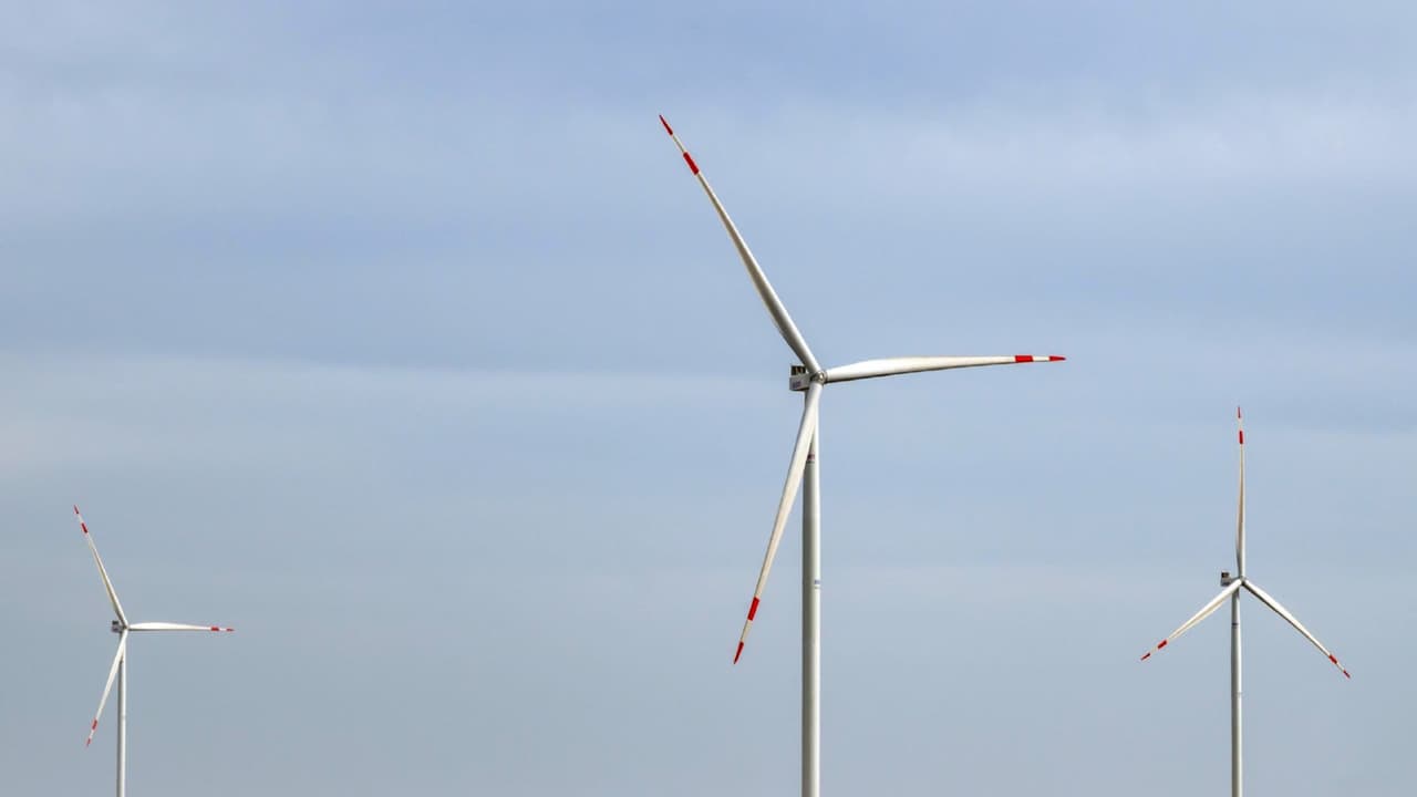 A vast solar power array with wind turbines at a renewable energy facility. (File Photo ANI) A vast solar power array with wind turbines at a renewable energy facility. (File Photo ANI)