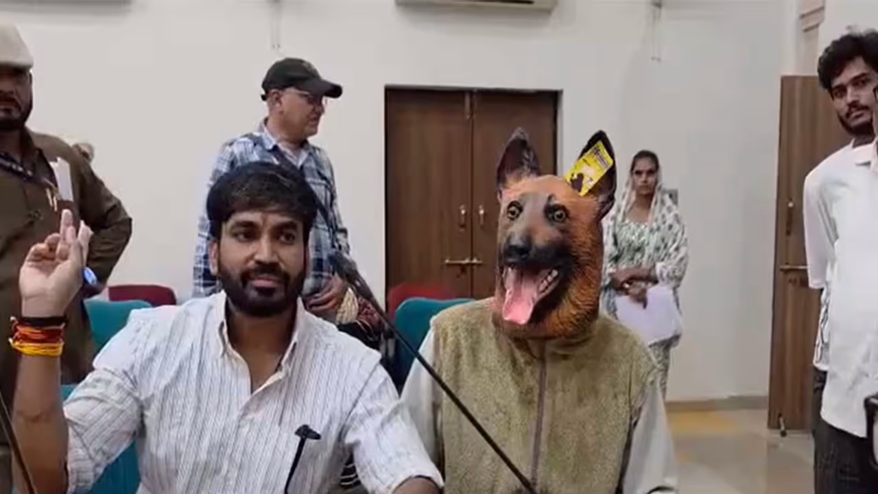 Khandwa Municipal Corporation Leader of Opposition Mullu Rathore with a person wearing a dog mask (Photo/ANI) Khandwa Municipal Corporation Leader of Opposition Mullu Rathore with a person wearing a dog mask (Photo/ANI)