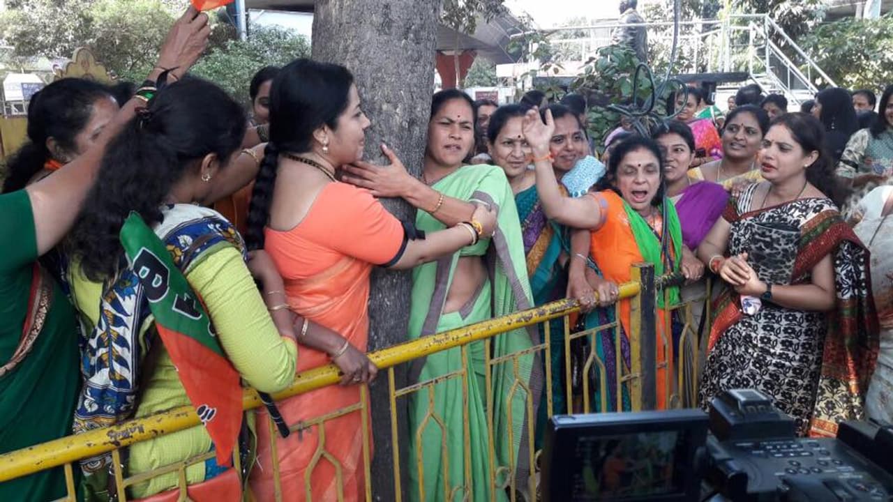 Women hug trees, say no to steel bridge Women hug trees, say no to steel bridge