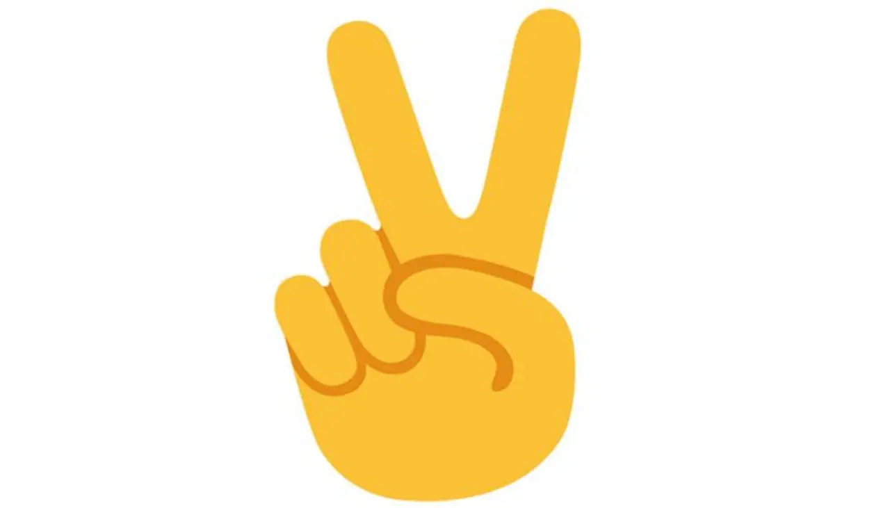 What you think: A peace emoji or an emoji that says, “Two please.” What it actually means: The emoji represents victory. What you think: A peace emoji or an emoji that says, “Two please.” What it actually means: The emoji represents victory.
