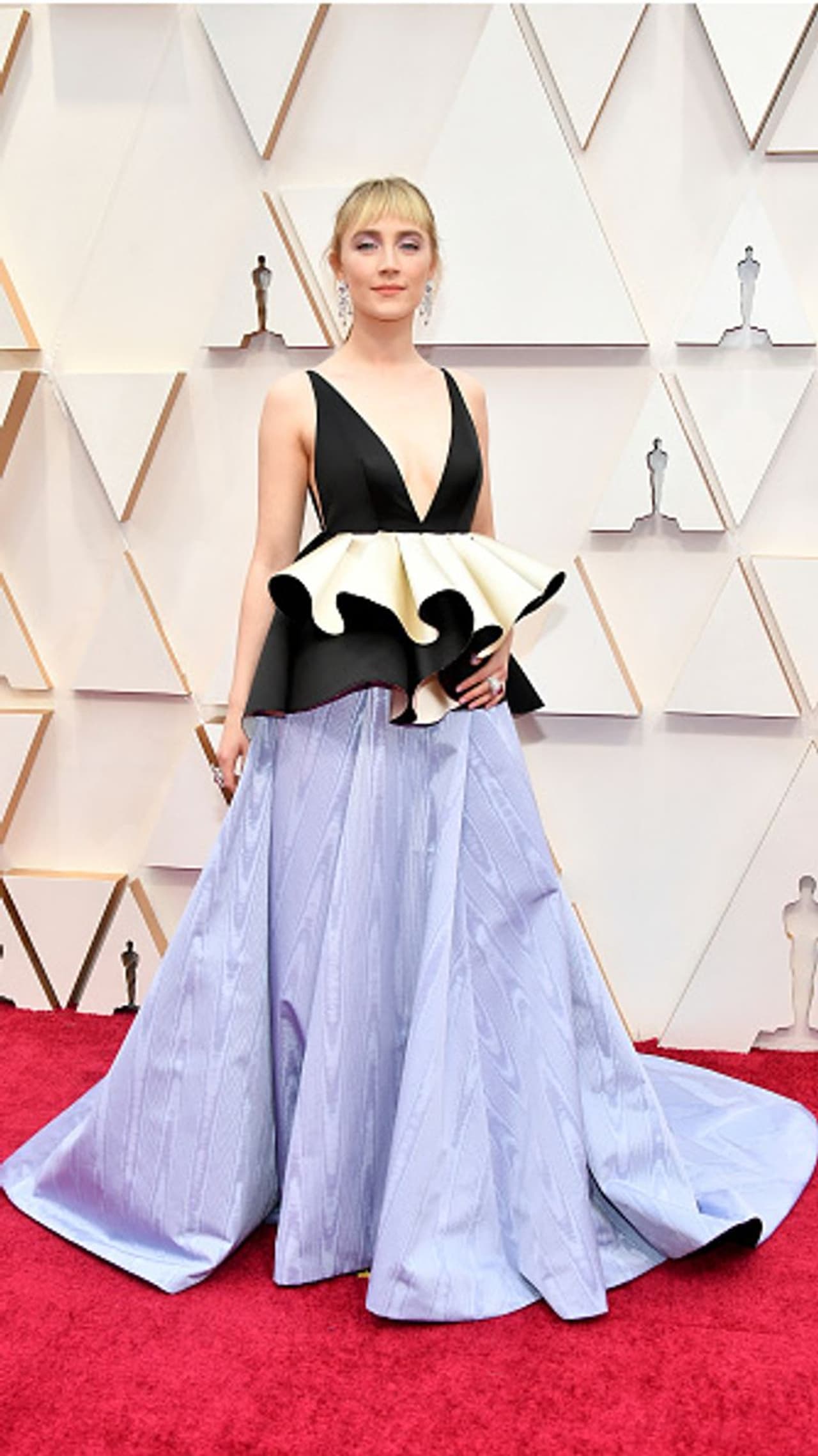 Saoirse Ronan: Little Women star Saoirse opted for a ruffled Gucci gown with a plunging neckline and showed off a choppy new fringe hairstyle. Saoirse Ronan: Little Women star Saoirse opted for a ruffled Gucci gown with a plunging neckline and showed off a choppy new fringe hairstyle.