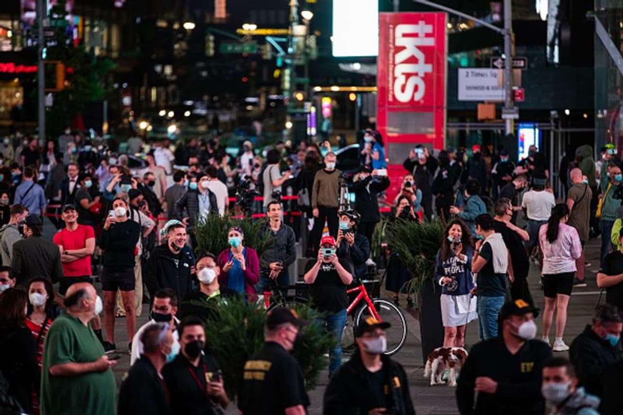 <p>People gather before billboards go momentarily dark in Times Square in a show of support for restaurants, hospitality businesses and non profits during the coronavirus crisis on May 27 in New York City.</p> <p>People gather before billboards go momentarily dark in Times Square in a show of support for restaurants, hospitality businesses and non profits during the coronavirus crisis on May 27 in New York City.</p>