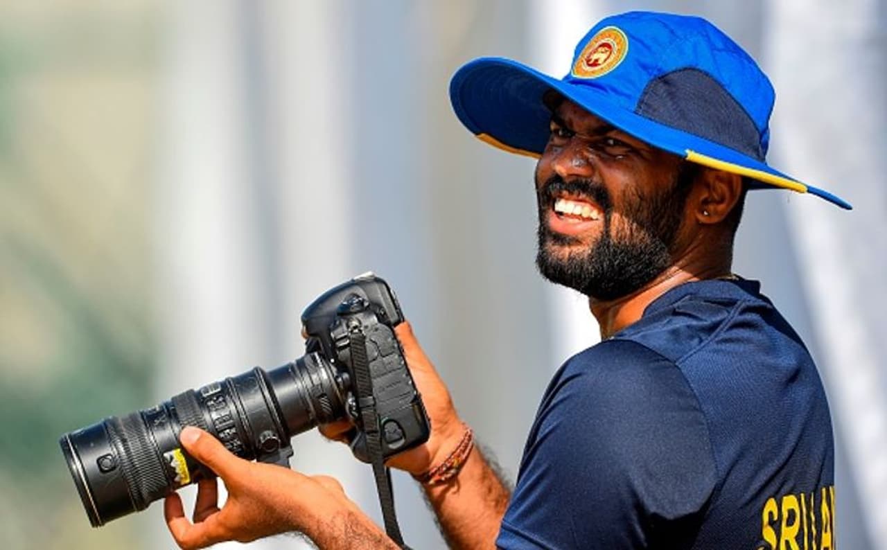 <p>Sri Lankan cricketer Lahiru Kumara looks on as he holds a camera during a practice session at the Galle International Cricket Stadium in Galle on August 12, 2019. The first Test between New Zealand and Sri Lanka will be played on August 14 at the Galle International Cricket Stadium in Galle.</p>