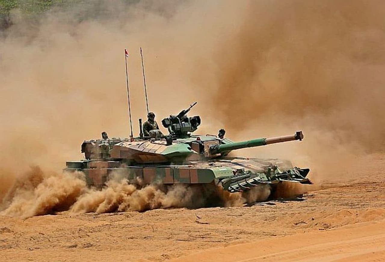<p>Prime Minister Narendra Modi on Sunday handed over the indigenously built Arjun Main Battle Tank (MK 1A) to the Indian Army.<br />&nbsp;</p><p>On the occasion, Indian Army chief Gen MM Naravane and DRDO Chairman G Sateesh Reddy were also present.&nbsp;<br />&nbsp;</p><p>Designed, developed by DRDO’s Chennai based Combat Vehicles Research and Development Establishment and manufactured by Avadi based Ordnance Factory Board, the tank weighs 68 tonnes and features a 120mm main gun with 71 other upgrades.&nbsp;<br />&nbsp;</p><p>As per the report, a total of 118 Arjun tanks will be inducted into the army.&nbsp;<br />&nbsp;</p><p>The Ministry of Defence has approved the induction of 118 Arjun tanks worth Rs 8,400 crore.&nbsp;<br />&nbsp;</p><p>These tanks would form two regiments in the Armoured Corps and add to the first batch of 124 Arjun tanks which have already been deployed on the western deserts along the Pakistan front.</p>