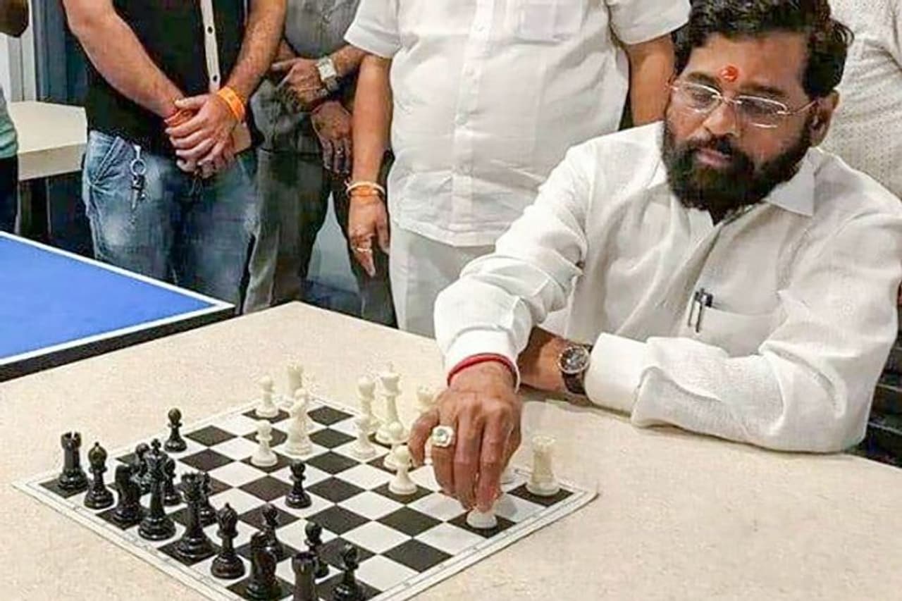 Image: Rebel Shiv Sena leader Eknath Shinde plays chess at a hotel where he is staying with supporting MLAs, in Guwahati. Photo: PTI Photo