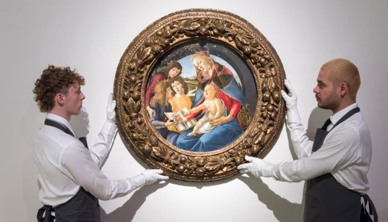 <I>Image: Art handlers hold a painting titled 'Madonna of the Magnificat' by Alessandro Filipepi, called Sandro Botticelli during a photo call to present the highlights from the estate of the philanthropist and co founder of Microsoft, Paul G Allen in London, United Kingdom. Photograph: Wiktor Szymanowicz/Anadolu Agency via Getty Images</I>