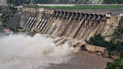 The gates of the Salal Dam open as the Chenab river swells up due to heavy rainfall