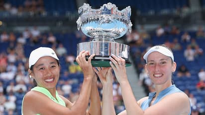 Elise Mertens (R) of Belgium and Shuai Zhang (L) of China