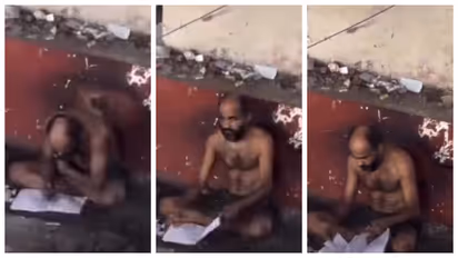 person studying just sitting outside the metro station