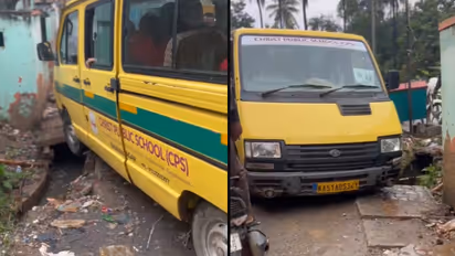 Bengaluru school van stuck in open drain amid poor roads