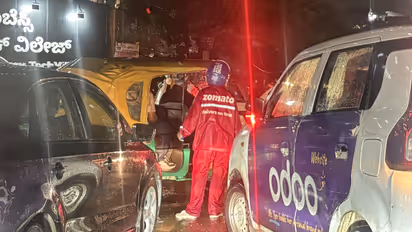 Zomato delivery agent directing traffic in Bengaluru during heavy rain and gridlock