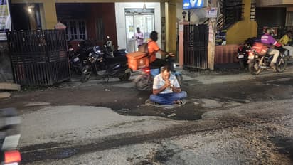 Bengaluru resident protests dangerous potholes by sitting on busy road