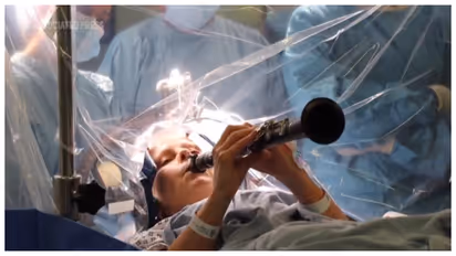 woman with Parkinson’s disease plays clarinet during brain surgery