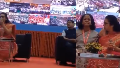 Postal officers erupts on stage as Nitin Gadkari looks on