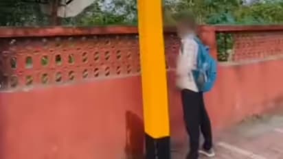 man urinating in railway station 