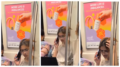 woman busy working with laptop in Delhi Metro 